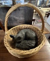 Bronzed resin model of a sleeping fox presented in a wicker basket, fox approx 30cm wide