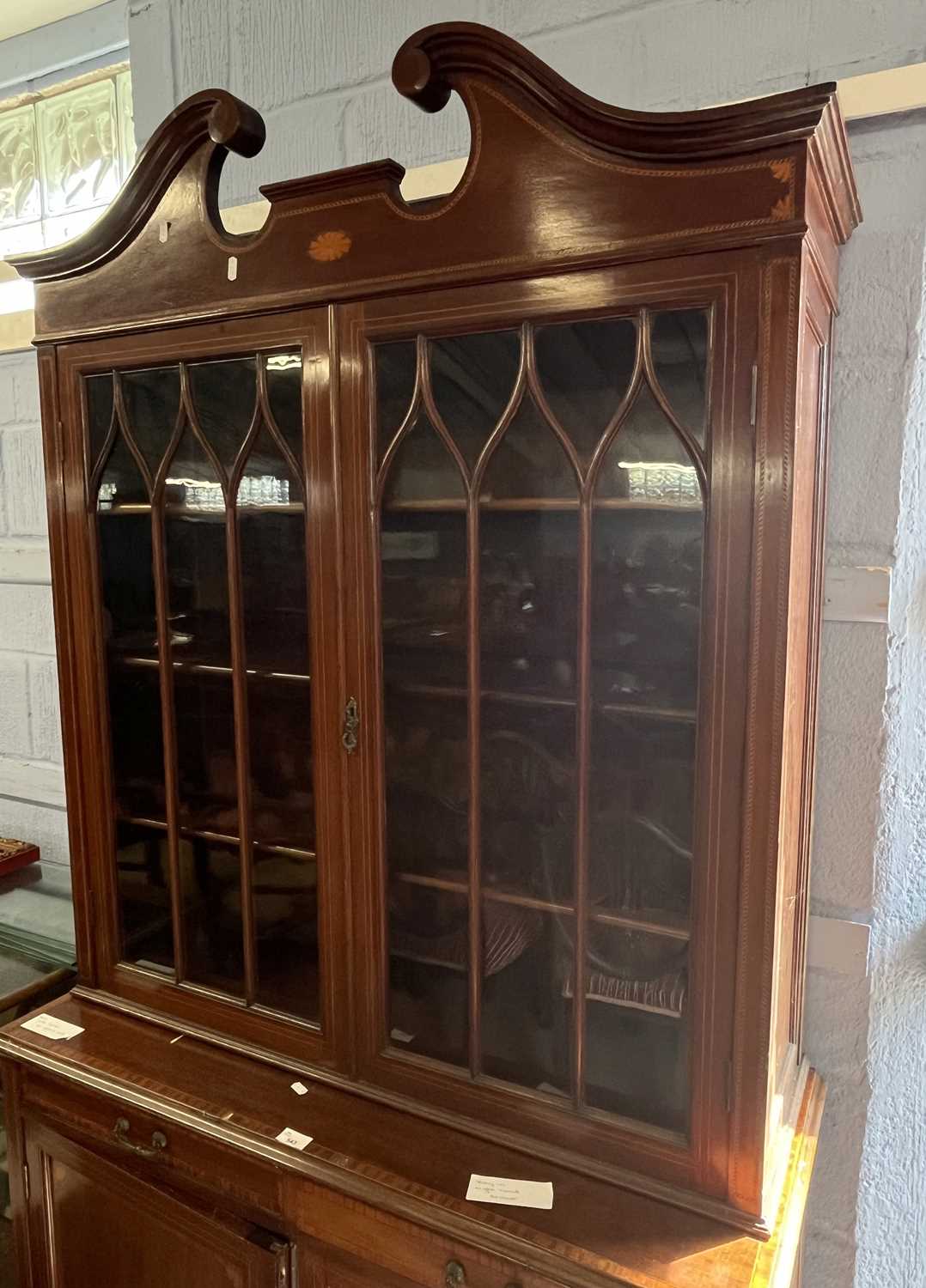 An Edwardian mahogany side cabinet with broken arch pediment over two astragal glazed doors and a - Image 2 of 2