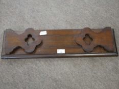 Late 19th century hardwood folding book rack with pierced ends, 60cm wide unextended