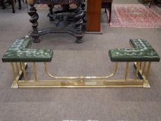 Brass club fender with green leather top over brass columns and a swept base, 138cm wide Interior