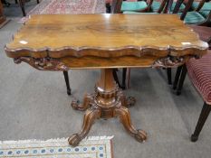 Victorian rosewood veneered card table with hinged revolving top over a tapering and carved column
