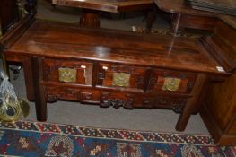 Low Chinese hardwood side table with three drawers, applied carved decoration, 125cm wide