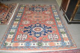 20th Century Afghan wool rug decorated with a large central panel with geometric lozenges surrounded