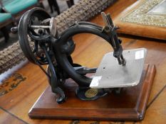 Wilcox & Gibbs sewing machine, raised on a hardwood base