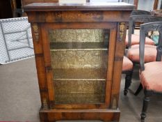 An Edwardian mahogany side cabinet with broken arch pediment over two astragal glazed doors and a