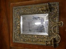 Arts & Crafts style brass framed bevelled wall mirror with attached two light sconces, 36cm max