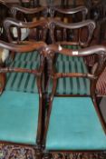 A set of William IV or early Victorian mahogany framed dining chairs with carved backs and