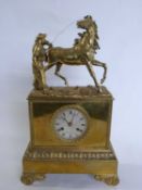 A gilt brass mantel clock, the dial marked Pons Paris with Middle Eastern figure and horse above,