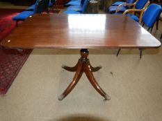 A Victorian mahogany small dining table with rectangular top raised on a turned column with four