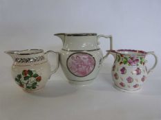 Group of three lustre jugs one with a puce printed design, further Greys Pottery decorated with