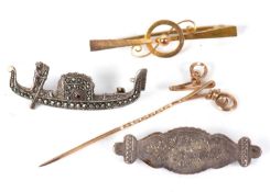 Four brooches:to include a bar brooch, 4.7cm long, indistinctly stamped 9ct, 1.5g; an initialled 'W'