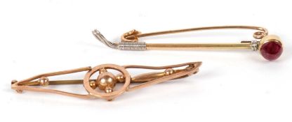 Two bar brooches:a riding crop bar brooch set with a red cabochon, 5cm long, unmarked, 3.2g;