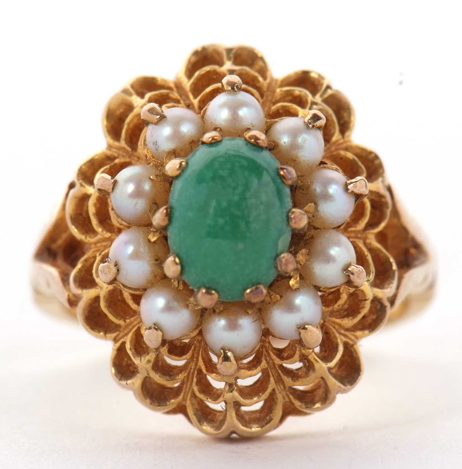 A 9ct turquoise and split pearl ring, the central oval turquoise cabochon surrounded by split pearls