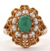 A 9ct turquoise and split pearl ring, the central oval turquoise cabochon surrounded by split pearls