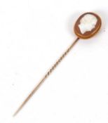 A cameo stick pin, the oval shell cameo, carved with a bust of a gentleman, collet mounted with rope
