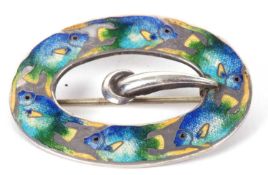 An enamelled buckle/brooch, the oval unmarked white metal buckle, (tests as silver), enamelled