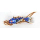 An enamelled fish pendant and 9ct chain, the blue and white articulated fish pendant with red