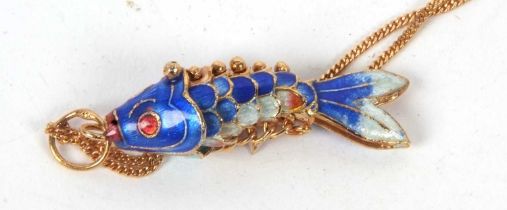 An enamelled fish pendant and 9ct chain, the blue and white articulated fish pendant with red