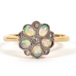 An 18ct and platinum opal and diamond ring, the flowerhead cluster with oval opal cabochon petals