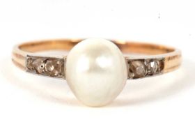 A 'pearl' and diamond ring, the central 'pearl', approx. 8.5mm diameter, set to either side with