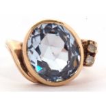 A blue spinel and white stone ring, the oval mixed cut spinel in a rubover mount, set