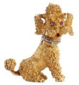 An 18ct poodle brooch, the seated poodle set with ruby eyes and diamond collar, stamped 750 to