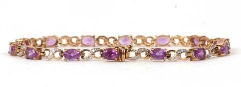 A 9ct amethyst and diamond bracelet, the oval claw mounted amethysts interspaced with overlapping