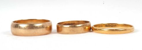 Three gold rings: to include a 22ct wedding band, London 1952, size U, 3.0g, a 9ct wedding band,