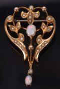 An Edwardian opal and seed pearl brooch, set to centre with an oval opal cabochon and another