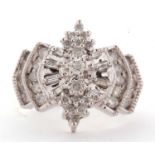 A 14ct diamond ring, the Odeonesque style ring set with round brilliant and baguette cut diamonds,