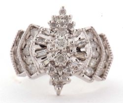 A 14ct diamond ring, the Odeonesque style ring set with round brilliant and baguette cut diamonds,