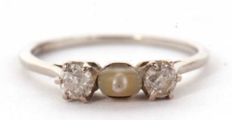 A diamond and 'pearl' ring, the central off-round 'pearl' set to either side with an old mine cut