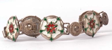 A silver and enamel bracelet, the five Tudor rose style enamelled links, each stamped 'silver' to