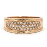 A 9ct diamond ring, the 8mm wide band set with small round diamonds, with rope twist border