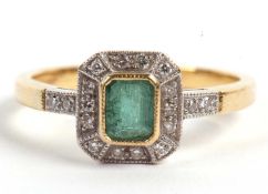 An 18ct emerald and diamond ring, the central step cut emerald surrounded by small round diamonds,