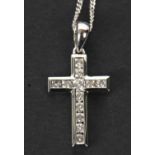 An 18ct and diamond cross and chain, the cross with channel set round brilliant cut diamonds, with