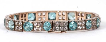 An early 20th century blue zircon and white stone bracelet, set with graudating round blue zircons