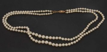 A cultured pearl necklace, the two graduated strands of round cultured pearls, with 9ct clasp
