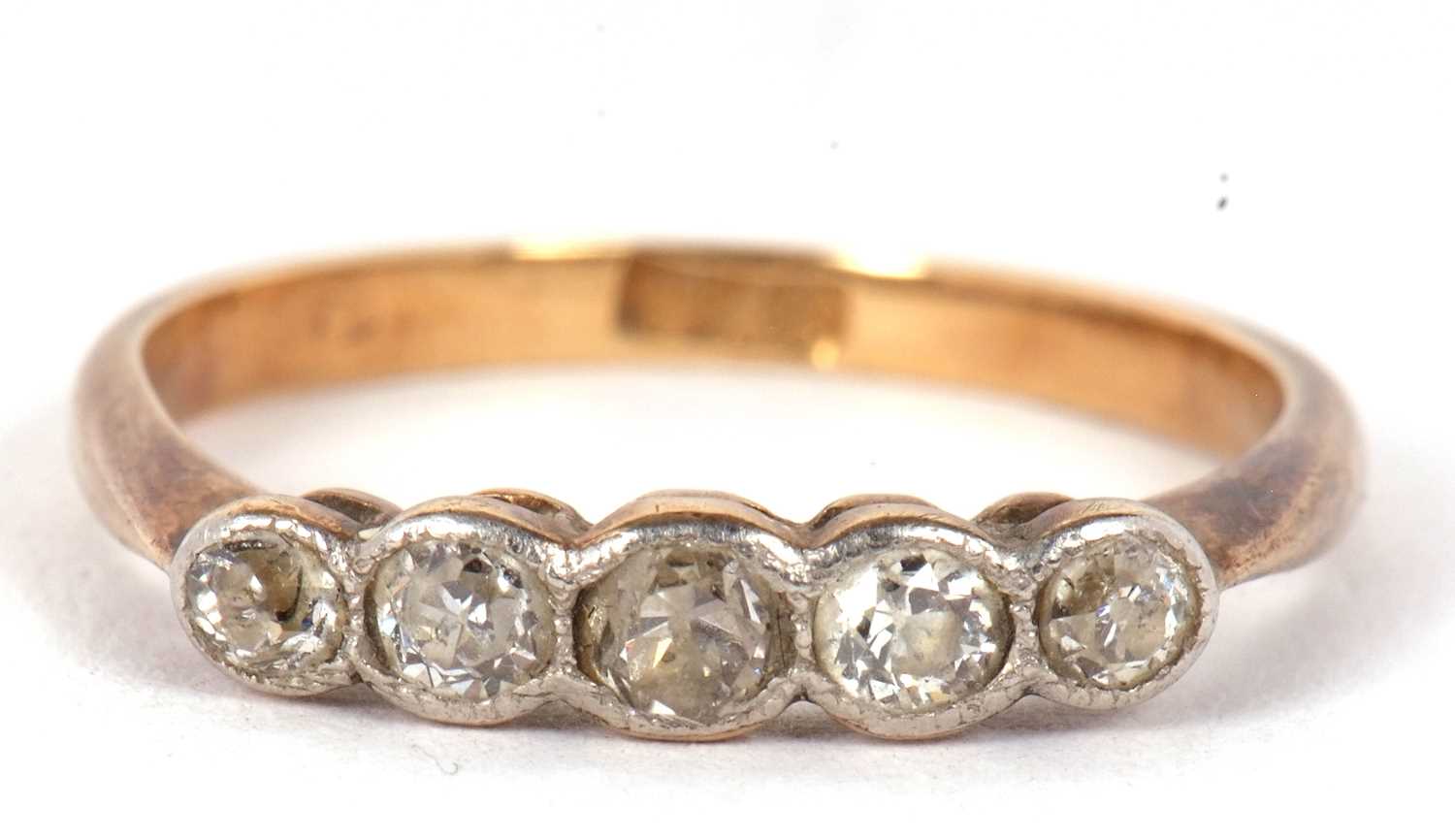 A five stone diamond ring, the five slightly graduated old European cut diamonds in millegrain
