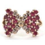 A 9ct ruby and diamond bow ring, the bow set with rubies and diamond detailing to centre, split