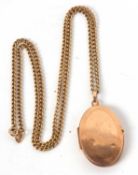 A locket and chain, the oval locket, 3.3cm long, with tapered bale stamped 375, on curblink chain