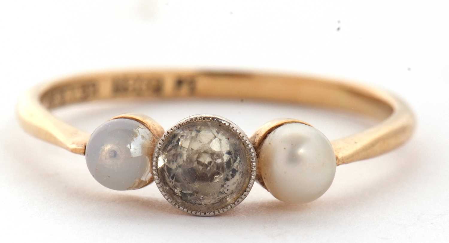 An 18ct three stone ring, set with a central white stone with a cultured pearl to either side, - Image 4 of 7