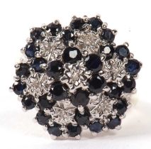 A 9ct sapphire and diamond cluster ring, the flowerhead design set with illusion set diamonds and