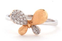 A two tone 18ct diamond butterfly ring, the wings alternately diamond pave and rose gold, to a plain