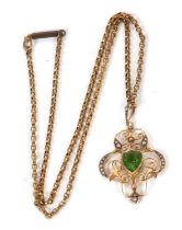 An Edwardian peridot pendant and gilt metal chain, the central heart shaped peridot set within a