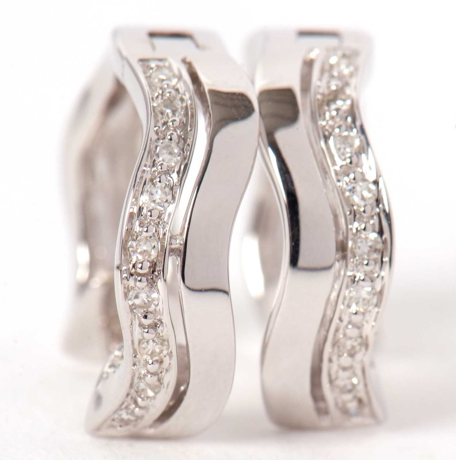 A pair of 9ct and diamond earrings, the hoops set with two undulating lines, one set with small - Image 5 of 5