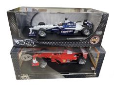 A pair of boxed Hotwheels 1:18 scale model racing cars, to include: - Williams F1, FW23 Juan Pablo