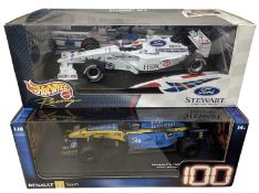 A pair of boxed Hotwheels 1:18 scale model racing cars, to include: - Renault's 100th GP Win, Sakhir