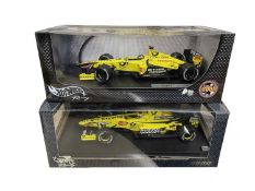 A pair of boxed Hotwheels 1:18 scale model racing cars, to include: - Jordan EJ11, Heinz-Harald