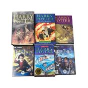A mixed lot of Harry Potter memorabilia, to include: - Chamber of Secrets, paperback edition - The